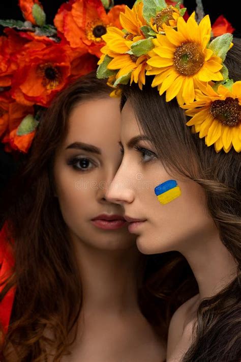 Two Beautiful Girls In Flower Wreaths Of Red Poppy And Yellow Sunflower