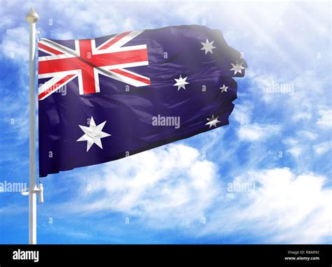 National Flag Of Australia On A Flagpole In Front Of Blue Sky Stock