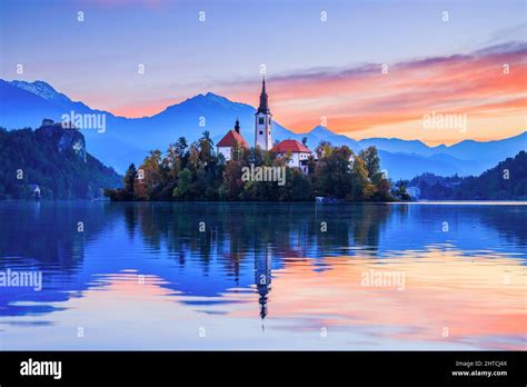 Lake Bled, Slovenia. Sunrise at Lake Bled with famous Bled Island and historic Bled Castle in ...