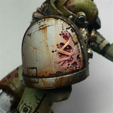 a close up of a warhammer with paint on it's face and helmet