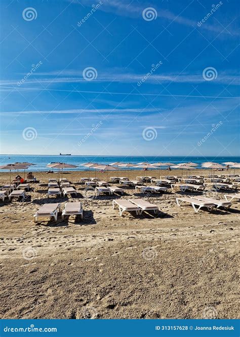 Beach with Sun Loungers Waiting for Tourists in Alicante Stock Photo