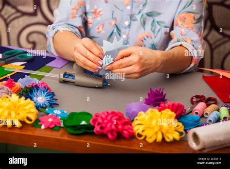 Woman modelling artificial flower from clay Stock Photo - Alamy