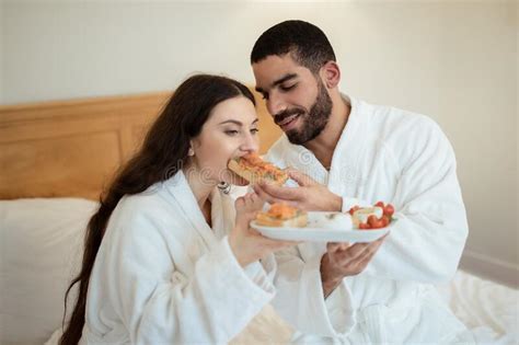 Husband Feeding Wife Giving Her Sandwich Having Breakfast In Bedroom Stock Image Image Of