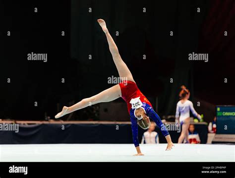 Woman Gymnast Performing Acrobatic On Floor Gymnastics Olympic Sports