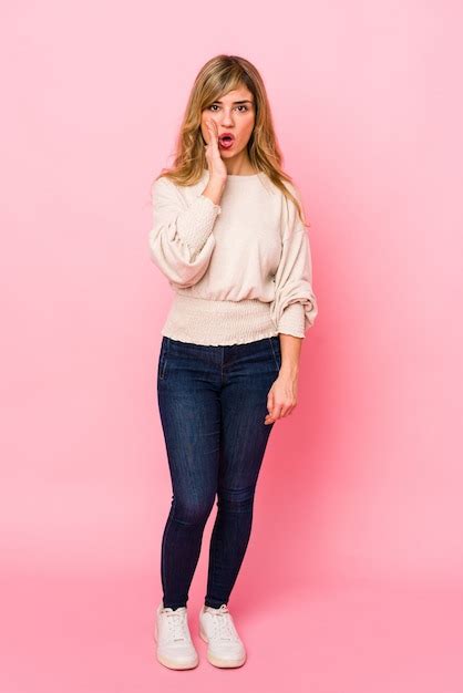 Premium Photo Young Blonde Woman Standing Over A Pink Wall Is Saying