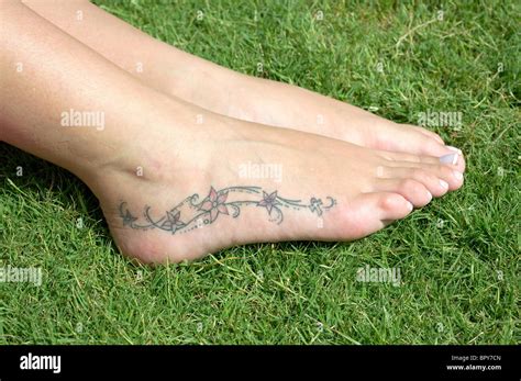 Tattoo on side of girl's foot Stock Photo - Alamy