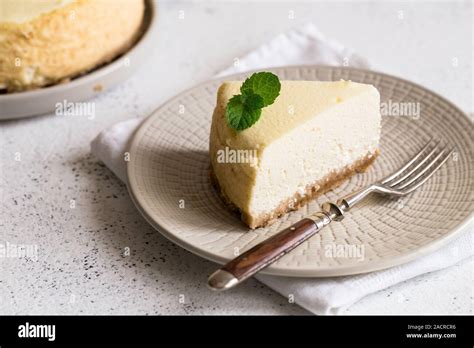 Slice Of Classical New York Cheesecake On White Plate Closeup View