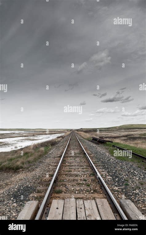 perspective view of railway in Canadian Prairies by cloudy day ...