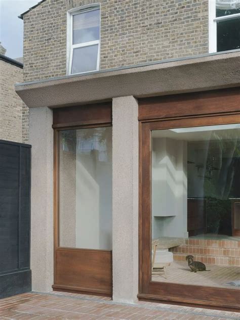 Cast House Extension By EBBA Features Brown Concrete And Vaulted