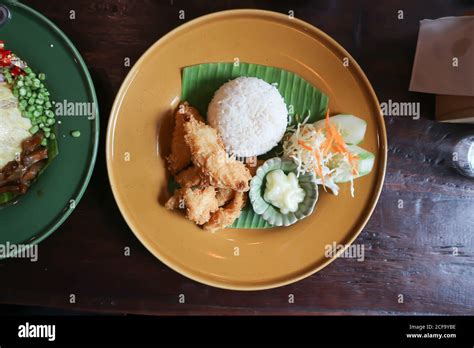 fried fish and rice, fried tilapia fish Stock Photo - Alamy