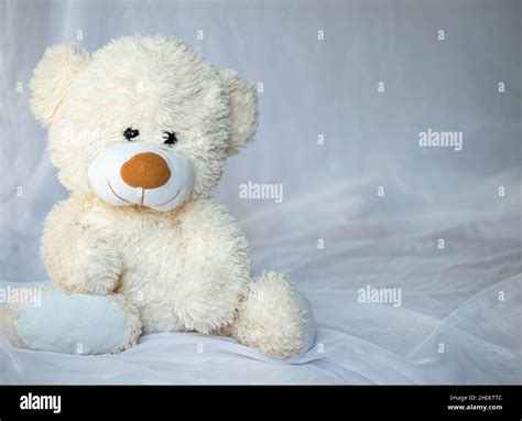 Teddy bear is sitting in bed Stock Photo - Alamy