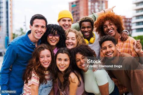 Happy Playful Multiethnic Group Of Young Friends Bonding Outdoors Stock