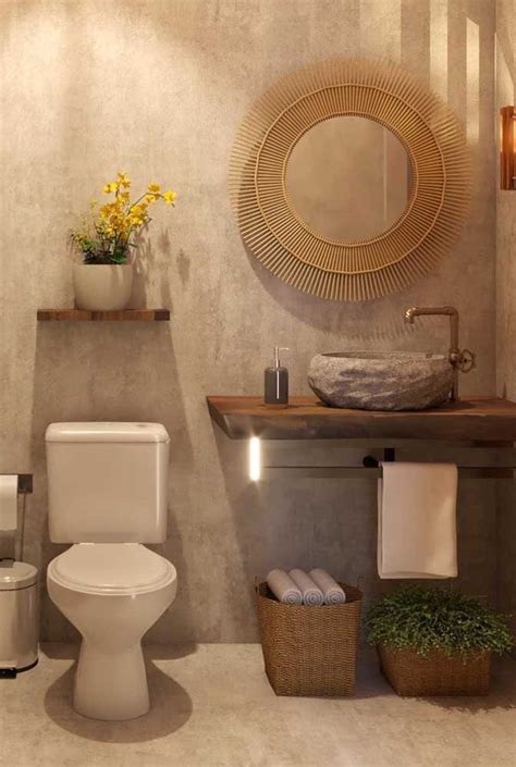 A White Toilet Sitting Next To A Sink In A Bathroom Under A Round Gold