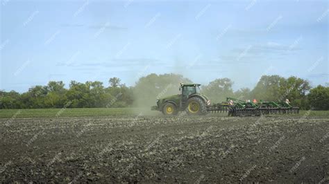 Premium Photo | Agricultural tractor plowing farming field farming ...