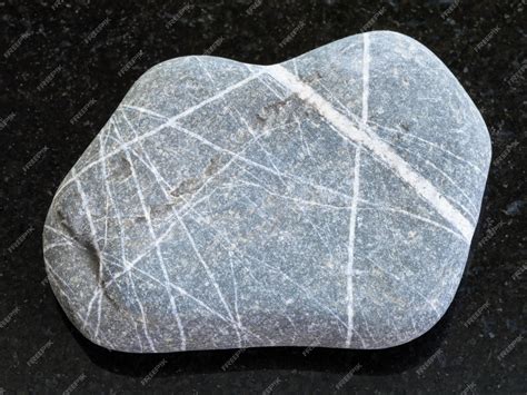 Premium Photo Pebble Of Greywacke Sandstone On Dark Background