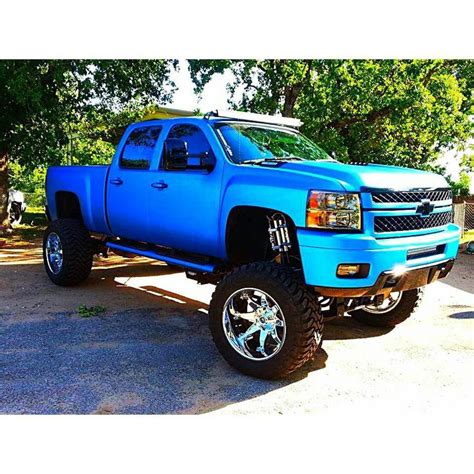 A Blue Truck Parked In A Parking Lot