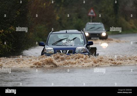 Cars Make Their Way Through Floods In The Village Of Norton Near