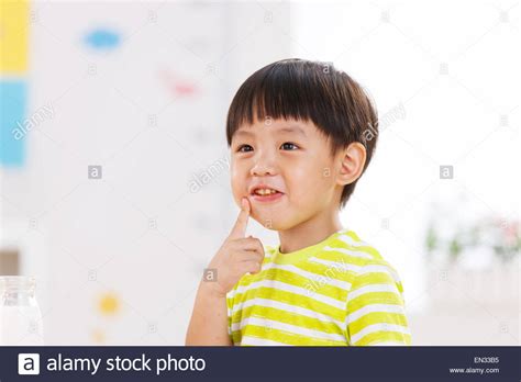 The Little Boy Is Chewing Food Stock Photo Alamy