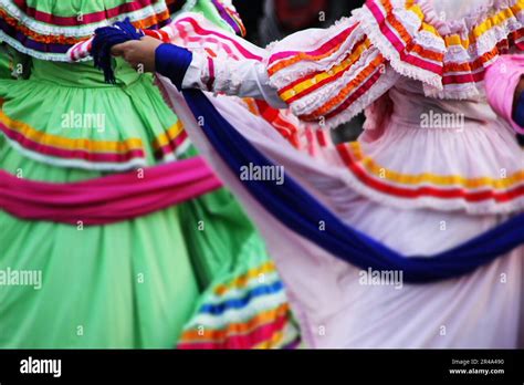 A group of Mexican folk dancers in festive costumes gather together for the celebration Stock ...