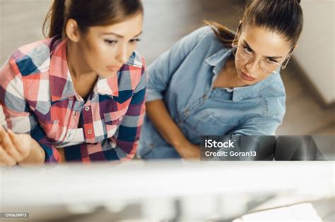 Above View Of Smiling Businesswomen Writing On Whiteboard In The Office