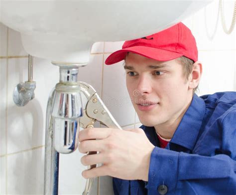 Plumber in uniform stock image. Image of pliers, smile - 29235113