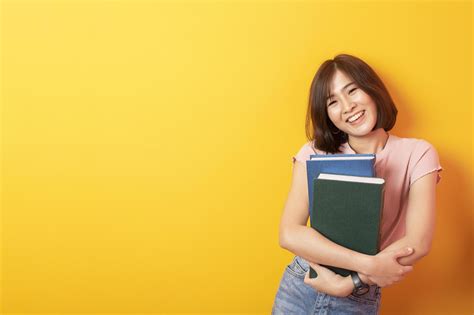 Beautiful asian woman University student happy on yellow background ...