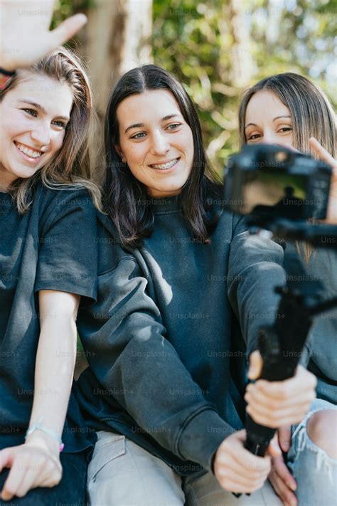 A Group Of Young Women Sitting Next To Each Other Photo Influencer