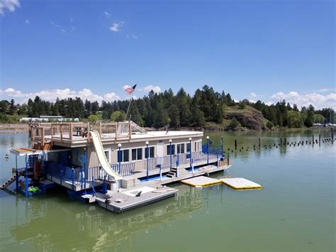 Floating House On Flathead Lake With Waterside Kayaks Rooftop Deck