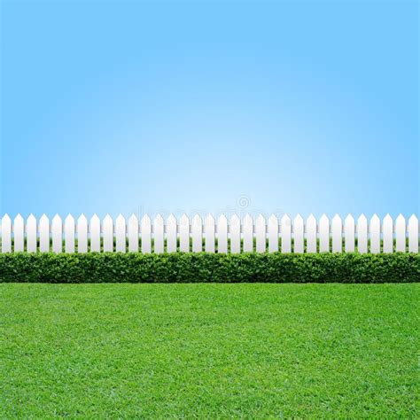 White fence and green grass. White fence and gree grass on blue sky , # ...