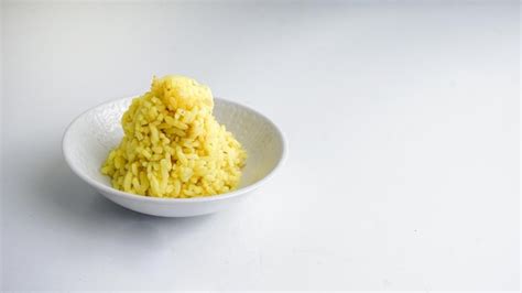 Premium Photo | Boiled yellow rice boiled in white bowl isolated on a ...