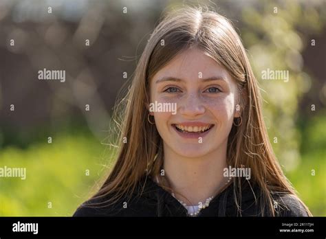 Portrait Of A Beautiful Happy Girl With Blond Hair And Freckles Looking