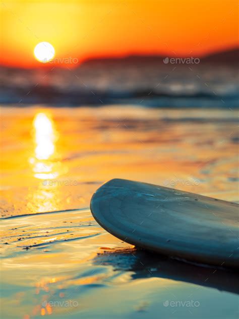 Surfboard On The Beach In Sea Shore At Sunset Time Stock Photo By Netfalls