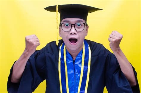 Premium Photo A Man Wearing A Graduation Cap And Gown With A Yellow