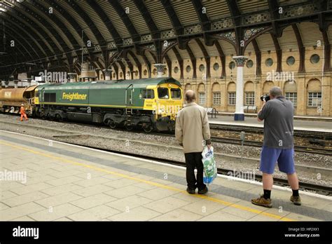 Rail enthusiast photographing a Freightliner Class 66 diesel loco at ...