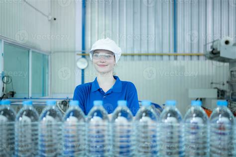 Drinking water factory worker at a production line of drinking water ...