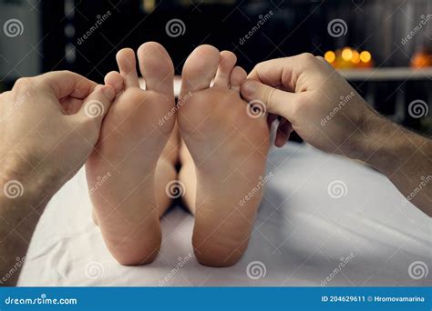 Male Hands Of A Massage Therapist Does A Woman Foot Massage Stock Image