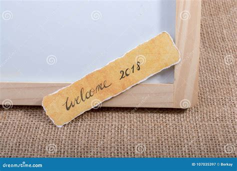 Welcome 2018 Wording Written On A Yellow Torn Paper Stock Image Image