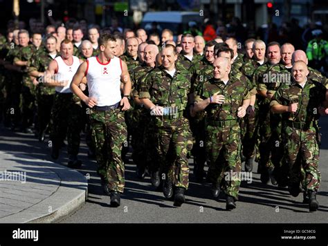 A Group Of Around 90 Former Royal Marines Speed March Through Trafalgar