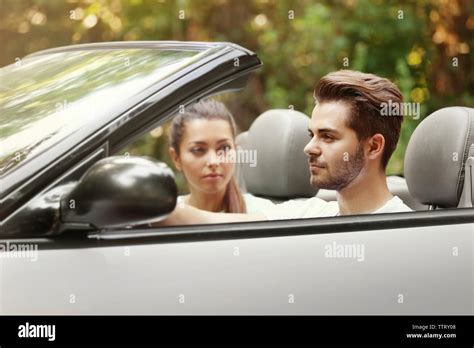 Beautiful couple in car on road trip Stock Photo - Alamy