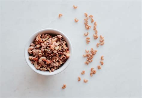 A White Bowl Filled With Cereal On Top Of A Table