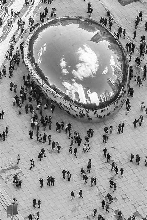 A Large Group Of People Standing Around In Front Of A Giant Water