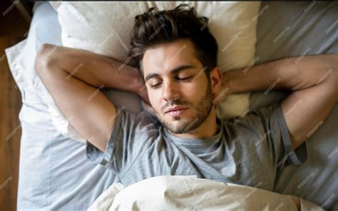 Premium Photo Attractive Young Man Sleeping In Bed