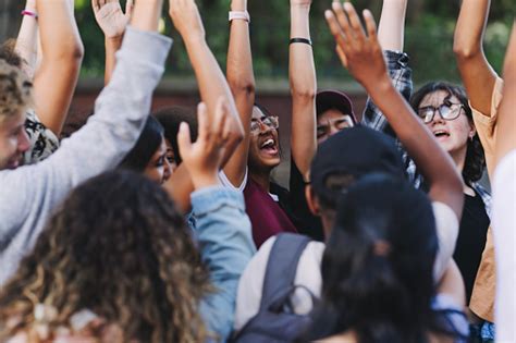 Happy Young People Cheering At A School Event Stock Photo - Download Image Now - Protest ...