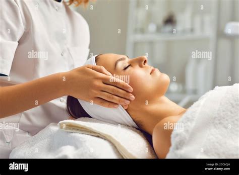 Spa Facial Massage Beautician Makes Face Massage To Woman In White