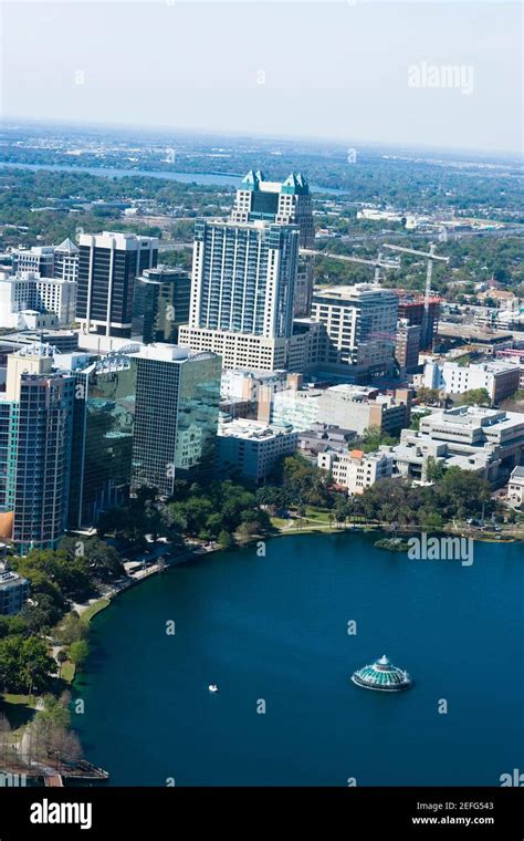 Aerial view of buildings along a lake, Lake Eola, Lake Eola Park ...