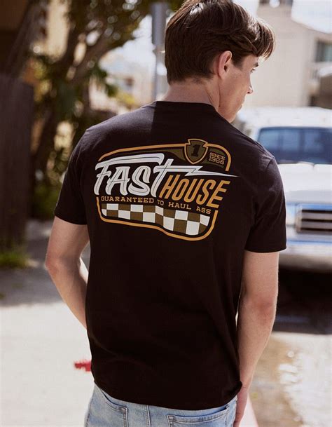 Boy Wearing Black Tee With Fast House Logo In The Back And Logo On