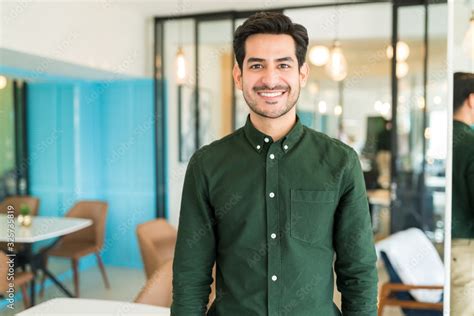 Businessman Standing In Corporate Office Stock Photo | Adobe Stock