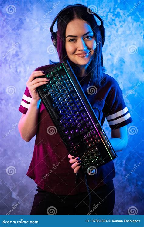 Beautiful Friendly Pro Gamer Streamer Girl Posing With A Keyboard In Her Hands Wearing Glasses