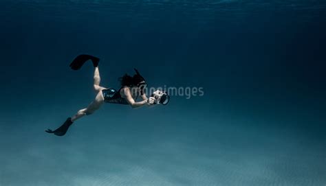 Underwater View Of Female Free Diver With Underwater Camera Bimini