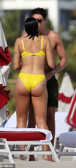 Dua Lipa Showcases Her Slender Figure In A Yellow Bikini For Beach Date